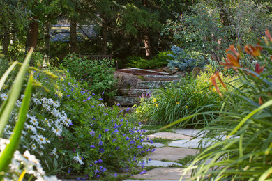 This is an example of a contemporary partial sun backyard stone landscaping in Denver for summer.