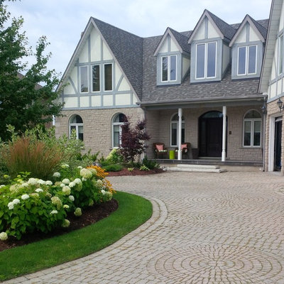 This is an example of a large traditional full sun front yard brick driveway in Toronto for summer.