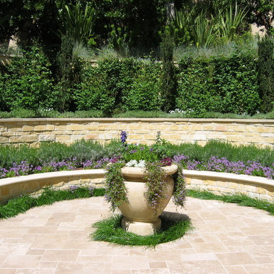Photo of a large mediterranean full sun courtyard brick retaining wall landscape in San Francisco.