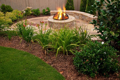 Imagen de jardín contemporáneo de tamaño medio en patio trasero con brasero, exposición total al sol y adoquines de piedra natural