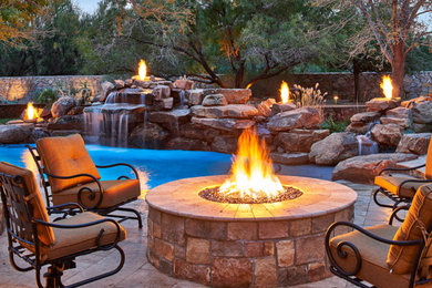 Design ideas for a large traditional back partial sun garden in Houston with a fire feature and natural stone paving.