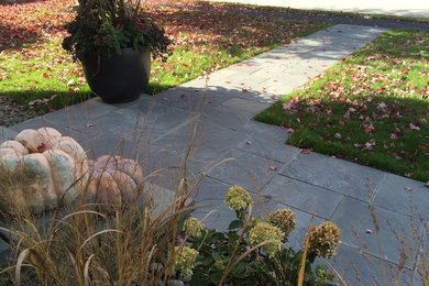 Inspiration for a small traditional partial sun front yard stone landscaping in Boston for fall.