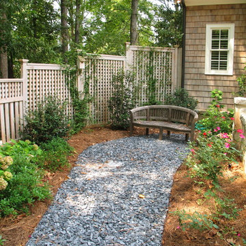 Back Porch & Backyard with Wooden Garden Bench terminating the Path