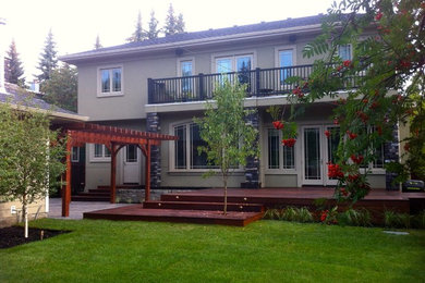 This is an example of a large contemporary backyard landscaping in Vancouver with decking.