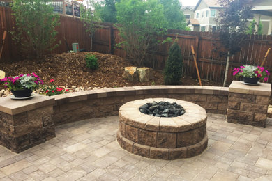 Design ideas for a backyard brick landscaping in Denver with a fire pit.