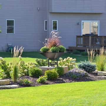 Backyard Berm with Outcrop Stones and Planter