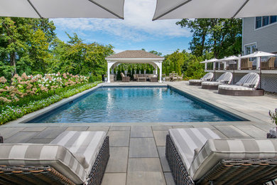 Example of a transitional backyard pool design in New York