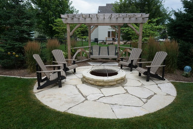 Diseño de patio tradicional de tamaño medio en patio trasero con brasero y adoquines de piedra natural