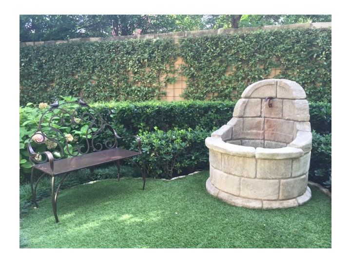 Inspiration for a mid-sized mediterranean backyard stone landscaping.