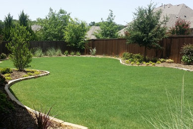Inspiration for a large traditional full sun backyard stone landscaping in Dallas.
