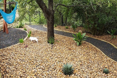 Photo of a large contemporary drought-tolerant and full sun backyard river rock walkway in Austin.