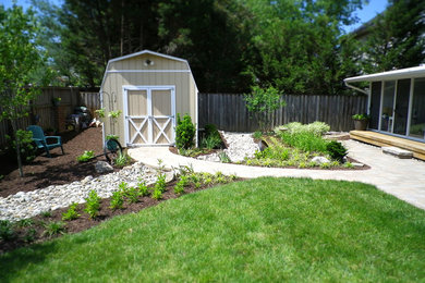 Large traditional back formal full sun garden for spring in DC Metro with natural stone paving.