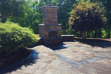 Design ideas for a mid-sized backyard concrete paver landscaping in Charlotte with a fire pit.