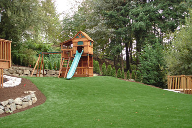 Photo of a large traditional drought-tolerant and partial sun backyard mulch outdoor playset in Portland.
