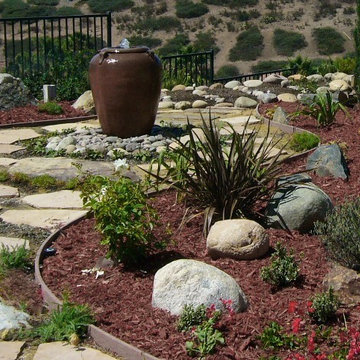 Backyard  redesign with recirculating water feature urn.