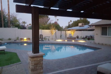 Photo of a large traditional backyard concrete paver landscaping in Phoenix.