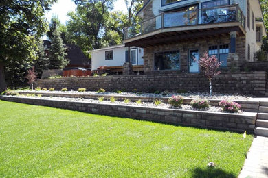 This is an example of a mid-sized traditional backyard retaining wall landscape in Minneapolis.