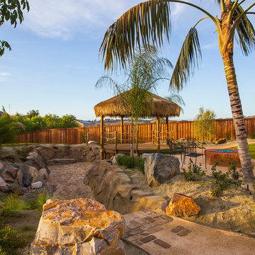 Backyard retreat with waterfall, dry river bed, and Palapa