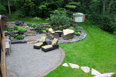Inspiration for a large modern partial sun backyard brick garden path in Toronto for summer.