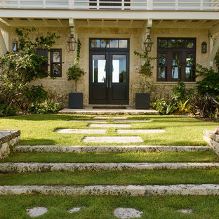 Photo of a tropical backyard stone landscaping in Miami.