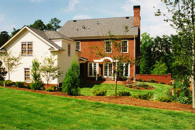 Photo of a mid-sized traditional shade backyard brick landscaping in Atlanta.