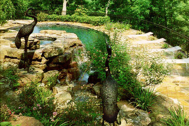 Photo of a mid-sized traditional full sun stone water fountain landscape in Atlanta for summer.