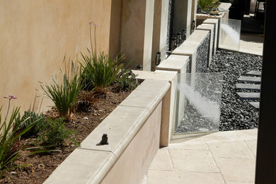 Inspiration for a mid-sized modern backyard concrete paver landscaping in Los Angeles.