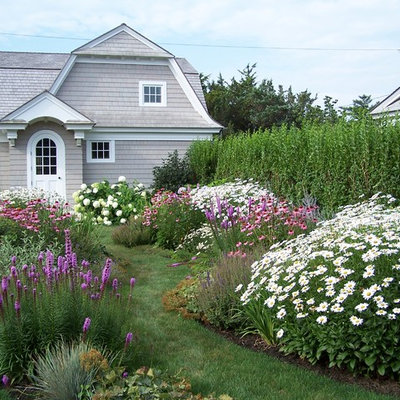 This is an example of a coastal full sun backyard formal garden in New York for summer.