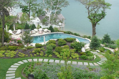Photo of a huge traditional partial sun backyard brick landscaping in New York for summer.