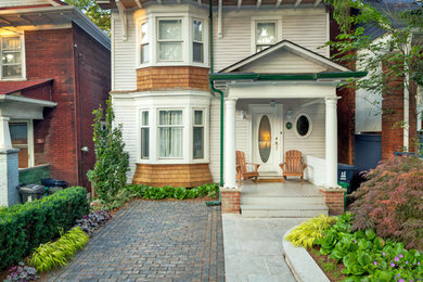 Inspiration for a small modern partial sun front yard brick driveway in Toronto for summer.