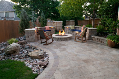 Inspiration for a mid-sized timeless backyard concrete paver patio remodel in Kansas City with a fire pit