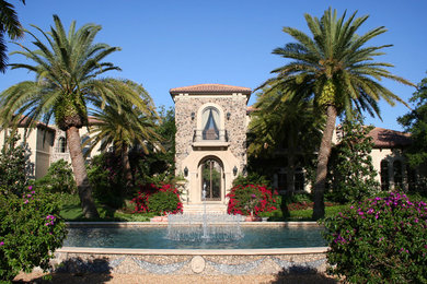This is an example of a huge traditional partial sun front yard stone landscaping in Miami for spring.