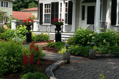 Large traditional front driveway fully shaded garden for summer in Boston with brick paving.