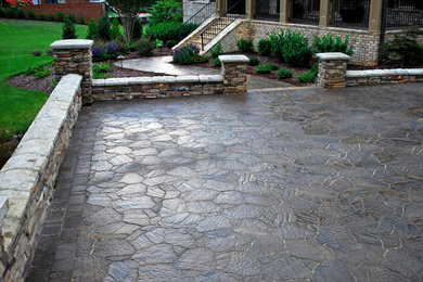 This is an example of a large traditional full sun courtyard concrete paver driveway in Raleigh.