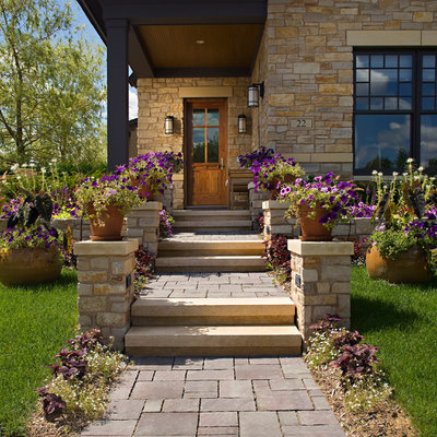 Design ideas for a mid-sized craftsman partial sun front yard stone formal garden in Orange County for summer.