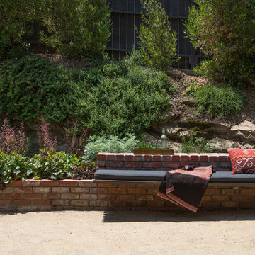 Bench seating in foreground with native plants on hillside in background