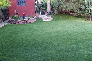 Photo of a mid-sized modern shade backyard landscaping in Denver.