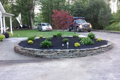 This is an example of a medium sized classic front partial sun garden for summer in New York with an outdoor sport court.