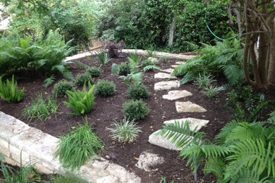 This is an example of a small traditional drought-tolerant and partial sun side yard gravel landscaping in Austin for summer.
