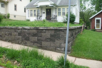 This is an example of a mid-sized front yard retaining wall landscape in Omaha.