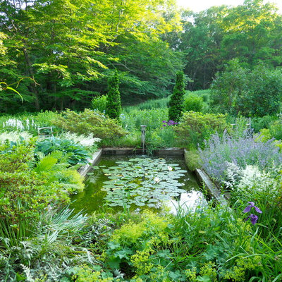 Inspiration for a large traditional partial sun backyard landscaping in Providence.