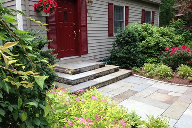 Photo of a mid-sized transitional partial sun front yard stone garden path in Boston.