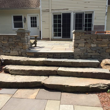 Bluestone Patio with natural edge steps and fieldstone wall