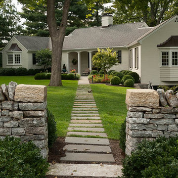 Bluestone step stone path pierces limestone wall and transitions to solid blues