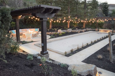 Photo of a large craftsman drought-tolerant and full sun backyard stone landscaping in San Francisco with a fire pit for fall.