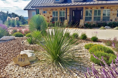 Photo of a mid-sized rustic drought-tolerant and full sun front yard gravel landscaping in Austin for summer.