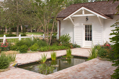 Design ideas for a medium sized classic courtyard formal full sun garden for summer in Houston with a water feature and brick paving.