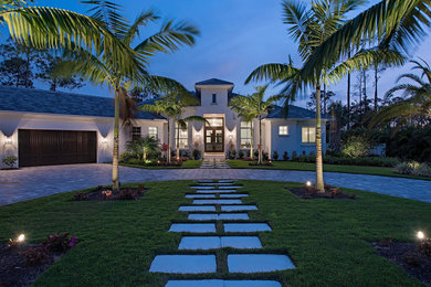 Design ideas for a contemporary front driveway full sun garden in Miami with brick paving.
