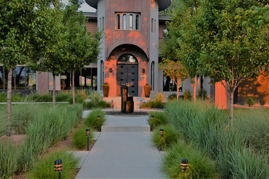 Medium sized modern front formal partial sun garden in Denver with a garden path and concrete paving.