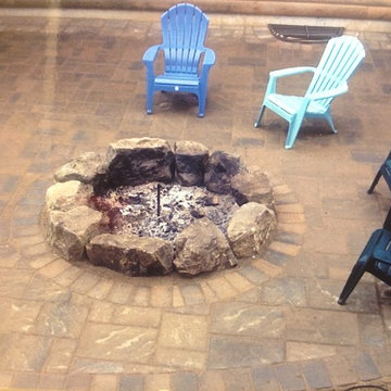 Boulder firepit in paver patio.